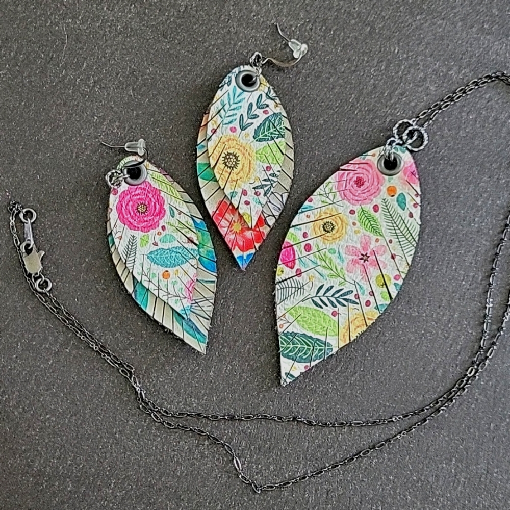 Handmade floral pattern cut leather feather earrings and necklace with gunmetal